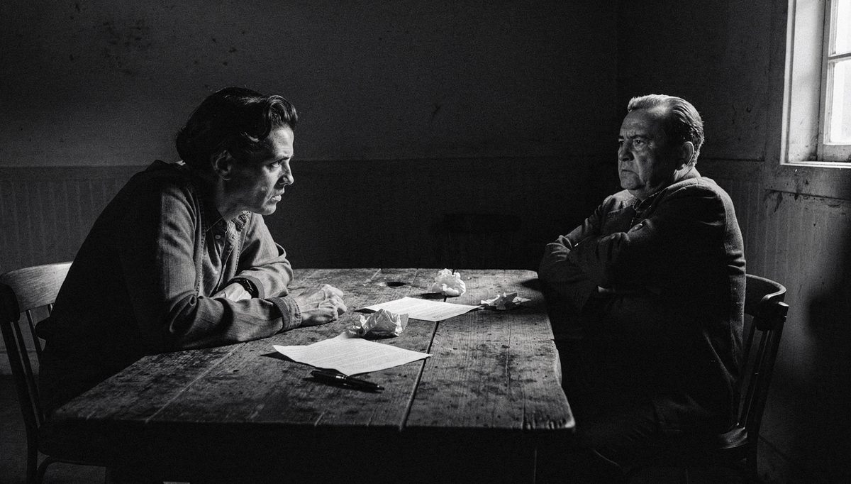 Two people in tense psychological safety negotiation across table
