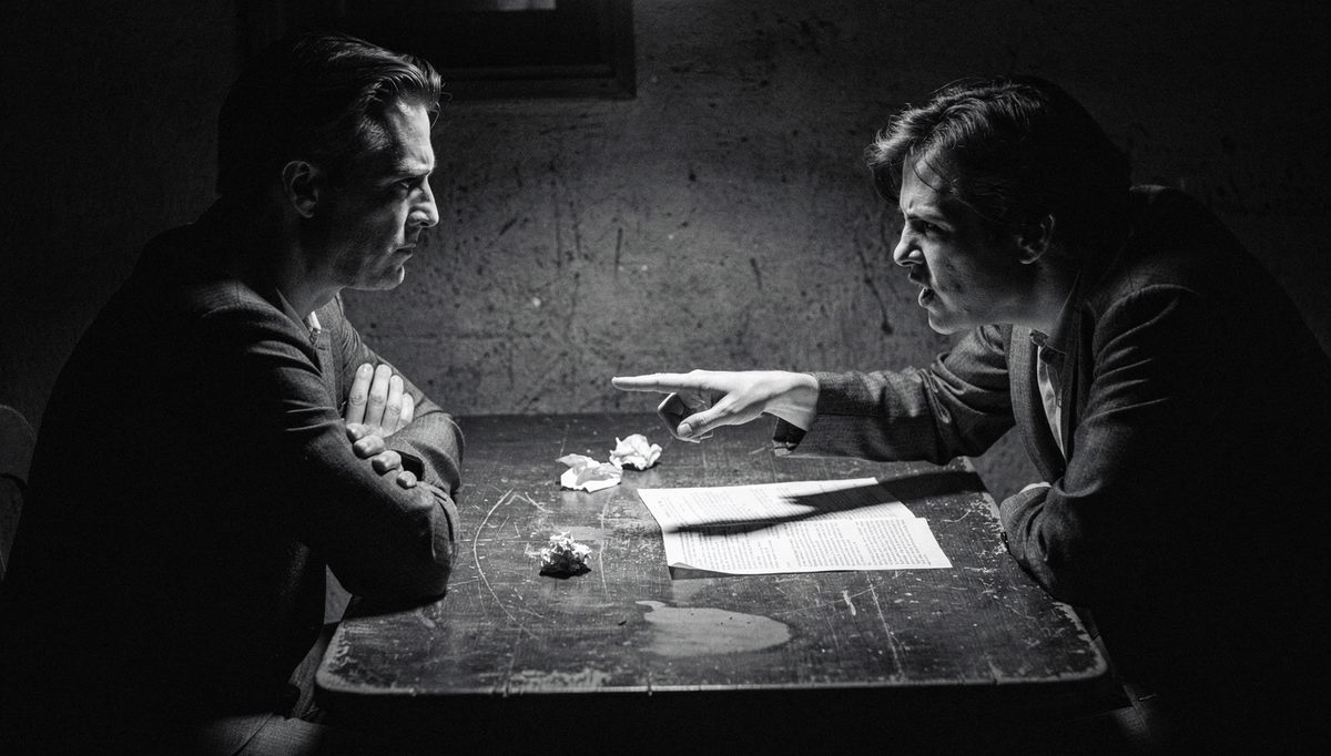 Two people in tense recurring conflict resolution discussion at table
