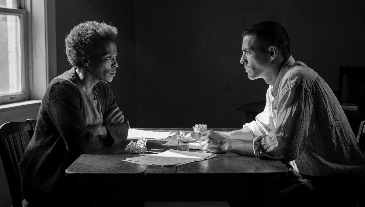 Two people in tense conflict under pressure at narrow table