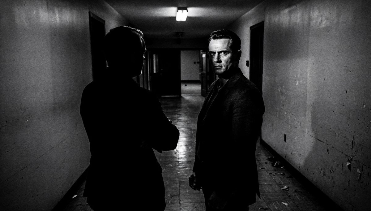 Two colleagues facing away in corridor, tension management failed