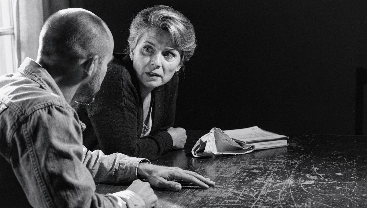 Woman listening intently to man in patient hearing example