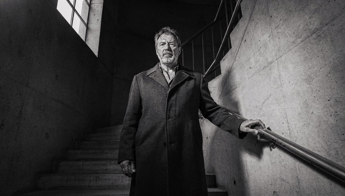 Man standing tall in stairwell, power poses emotional presence