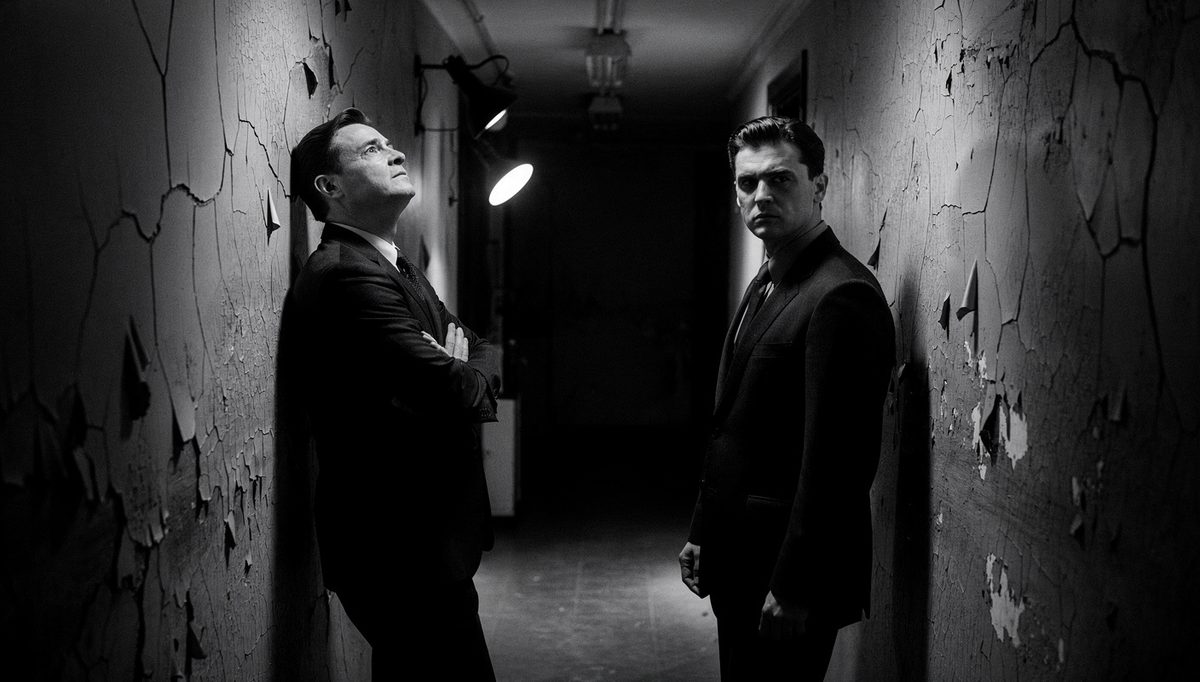 Two professionals using body language awareness in tense office corridor