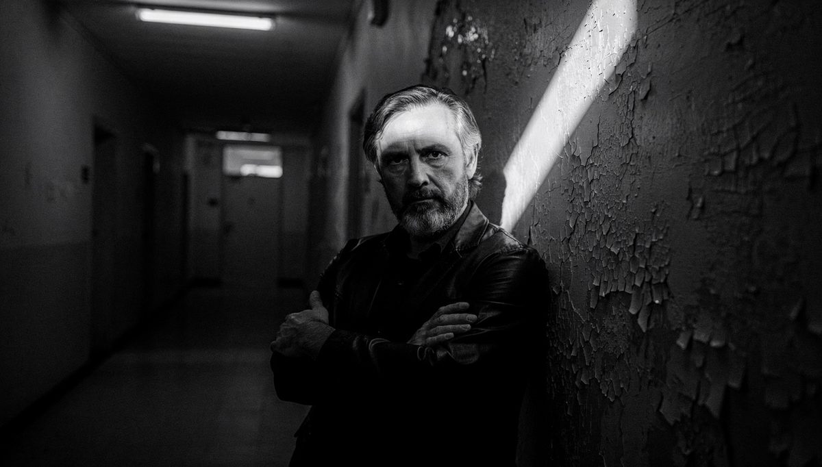 Man alone in shadowed corridor representing toxic trait escalation
